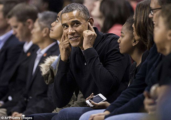 Obama Booed at College Basketball Game Covering His Ears Oregon State University of Maryland Michelle Obama's brother Craig Robinson head coach crowd cheers jeers unhappy ACA Obamacare promise keep your plan upset