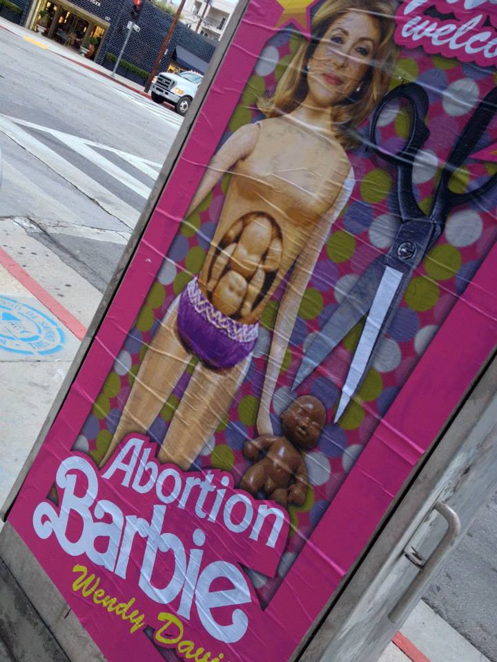 "Hollywood Welcomes Abortion Barbie Wendy Davis" posters poster Sabo Los Angeles L.A. artist subversive street art political conservative life-sized Democrat Democratic gubernatorial candidate Texas governor fundraiser traffic signal boxes greeted by plaster plastered Republican opponent Greg Abbott GOP guerrilla Red State Erick Erickson baby belly cut out scissors late-term partial birth abortions filibuster campaign edgy Kathryn Stuard Midland woman commissioned commission shock shocking satire satirical offensive demean demeaning