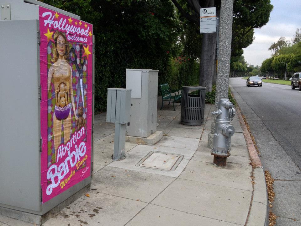 "Hollywood Welcomes Abortion Barbie Wendy Davis" posters poster Sabo Los Angeles L.A. artist subversive street art political conservative life-sized Democrat Democratic gubernatorial candidate Texas governor fundraiser traffic signal boxes greeted by plaster plastered Republican opponent Greg Abbott GOP guerrilla Red State Erick Erickson baby belly cut out scissors late-term partial birth abortions filibuster campaign edgy Kathryn Stuard Midland woman commissioned commission shock shocking satire satirical offensive demean demeaning
