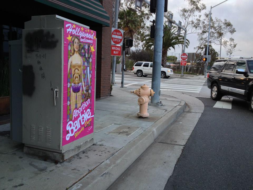 "Hollywood Welcomes Abortion Barbie Wendy Davis" posters poster Sabo Los Angeles L.A. artist subversive street art political conservative life-sized Democrat Democratic gubernatorial candidate Texas governor fundraiser traffic signal boxes greeted by plaster plastered Republican opponent Greg Abbott GOP guerrilla Red State Erick Erickson baby belly cut out scissors late-term partial birth abortions filibuster campaign edgy Kathryn Stuard Midland woman commissioned commission shock shocking satire satirical offensive demean demeaning