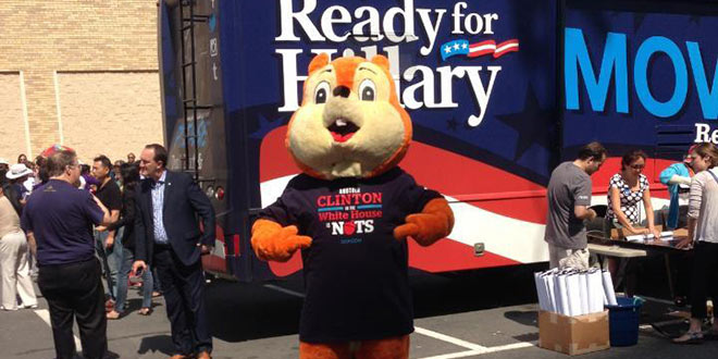 giant orange squirrel mascot suit man trolls Hillary Clinton book tour bus stop RNC intern Hard Choices chases trails tails dogs hounds follows GOP bumper stickers T-shirt “Another Clinton in the White House is nuts” Twitter account funny humorous hilarious awesome tweets tweeting tweeted "HRC Squirrel" @HRCSquirrel acorn fuzzy guy costume Justin Republican National Committee weapon combat media
