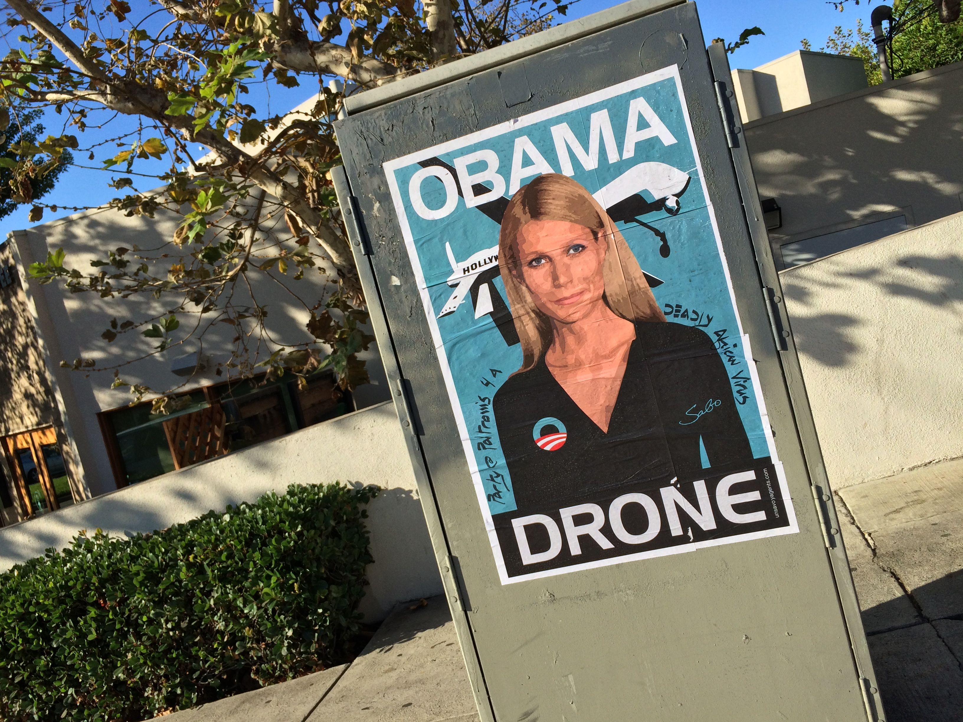 Gwyneth Paltrow Obama Drone posters poster Sabo President Obama DNC fundraiser L.A. Los Angeles Brentwood neighborhood neighbor neighbors hang hanging hung signs plaster plastering plastered traffic signal box boxes lamp posts bus benches anonymous conservative street artist provocative controversial subversive Unsavory Agents UnsavoryAgents outside political Democrats Democrat drones Predator plane planes flying background actor actress home house host hosting gala